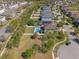 Drone shot of a property with an inviting pool area, complemented by mature landscaping and well-maintained lawns at 3384 Cordgrass Pl, Harmony, FL 34773