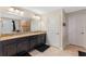 Spacious bathroom features a double vanity with granite counters and dark wood cabinets at 3384 Cordgrass Pl, Harmony, FL 34773