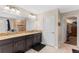 Bathroom with double vanity, granite counters, dark cabinetry and walk-in shower at 3384 Cordgrass Pl, Harmony, FL 34773