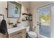 Bathroom with decorative shelves, modern fixtures, and natural light from the window at 3384 Cordgrass Pl, Harmony, FL 34773