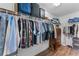 Walk-in closet featuring custom storage solutions including shelving and drawers at 3384 Cordgrass Pl, Harmony, FL 34773