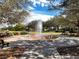Charming community fountain surrounded by seating, offering a peaceful gathering spot amid lush landscaping at 3384 Cordgrass Pl, Harmony, FL 34773