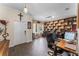 Home office with built in bookshelves and wood look floors at 3384 Cordgrass Pl, Harmony, FL 34773