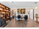 Home office with bookshelves, decor and wood look floors at 3384 Cordgrass Pl, Harmony, FL 34773