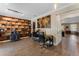 Home office with bookshelves, decor and wood look floors at 3384 Cordgrass Pl, Harmony, FL 34773