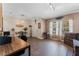 Bright home office featuring wood look floors, windows, and a comfortable workspace at 3384 Cordgrass Pl, Harmony, FL 34773
