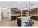 Modern kitchen with an island, granite countertops, stainless steel appliances, and a tile backsplash at 3384 Cordgrass Pl, Harmony, FL 34773