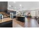 Spacious kitchen with stainless steel appliances, granite countertops, and dark wood cabinets at 3384 Cordgrass Pl, Harmony, FL 34773