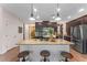 Kitchen featuring an island with seating, granite countertops, pendant lighting, and stainless steel appliances at 3384 Cordgrass Pl, Harmony, FL 34773