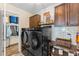 Laundry room with new washer and dryer and custom cabinets for storage at 3384 Cordgrass Pl, Harmony, FL 34773