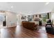 Comfortable living room with hardwood floors and multiple windows at 3384 Cordgrass Pl, Harmony, FL 34773