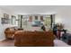 Bright living room with sofas, hardwood floors, and natural light at 3384 Cordgrass Pl, Harmony, FL 34773