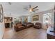 Cozy living room with a leather sofa set and a view of the kitchen and dining area at 3384 Cordgrass Pl, Harmony, FL 34773