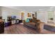 Bright living room with hardwood floors, sofas, and access to other rooms at 3384 Cordgrass Pl, Harmony, FL 34773