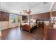 Main bedroom with hardwood floors, ceiling fan, and lots of natural light at 3384 Cordgrass Pl, Harmony, FL 34773