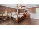 Bedroom featuring hardwood floors, a ceiling fan, and classic decor at 3384 Cordgrass Pl, Harmony, FL 34773