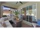 Relaxing screened patio featuring comfortable seating and sliding glass doors to the backyard at 3384 Cordgrass Pl, Harmony, FL 34773