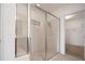 Modern bathroom with a glass shower, neutral tile and access to a walk-in closet at 3818 Carrick Bend Dr, Kissimmee, FL 34746