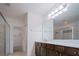 Bathroom with a large mirror, a long vanity with brown cabinets, and a glass-enclosed shower at 3818 Carrick Bend Dr, Kissimmee, FL 34746