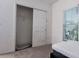 Simple bedroom includes a closet with sliding doors and a window for natural light, offering a clean, uncluttered space at 3818 Carrick Bend Dr, Kissimmee, FL 34746