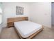 Modern bedroom with a platform bed, hardwood headboard and neutral carpet at 3818 Carrick Bend Dr, Kissimmee, FL 34746