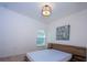 A bedroom with a minimalist design, featuring a platform bed with side table and modern wall art at 3818 Carrick Bend Dr, Kissimmee, FL 34746