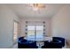 A dining area featuring a modern round table with blue velvet chairs, next to a large window with views at 3818 Carrick Bend Dr, Kissimmee, FL 34746