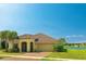 Charming home featuring a tile roof, manicured lawn, and inviting front entrance by a tranquil lake at 3818 Carrick Bend Dr, Kissimmee, FL 34746