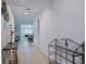 Inviting tiled hallway with neutral walls and decor leading to an open-concept living area at 3818 Carrick Bend Dr, Kissimmee, FL 34746