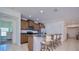 Bright kitchen with wood cabinetry, granite countertops and stainless steel appliances. Bar seating at the counter at 3818 Carrick Bend Dr, Kissimmee, FL 34746