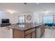 Spacious eat-in kitchen with granite countertops and stainless steel dishwasher and a view to the living area at 3818 Carrick Bend Dr, Kissimmee, FL 34746