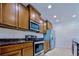 Modern kitchen features stainless steel appliances, dark countertops, and ample cabinet space for an efficient cooking area at 3818 Carrick Bend Dr, Kissimmee, FL 34746