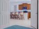 A view from a bedroom through double doors into a kitchen with barstool seating and wood cabinets at 3818 Carrick Bend Dr, Kissimmee, FL 34746