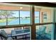 View of the water from the screened lanai with table and chairs, bringing nature indoors at 3818 Carrick Bend Dr, Kissimmee, FL 34746