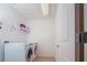 Bright laundry room with white appliances, shelving for storage, and a clean, functional design at 3818 Carrick Bend Dr, Kissimmee, FL 34746