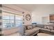 Inviting living room offers a lake view, comfortable seating, and a modern decorative shelf for a cozy atmosphere at 3818 Carrick Bend Dr, Kissimmee, FL 34746