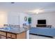 Open living space with a kitchen counter, inviting living room setup with a TV, and a tree for added ambiance at 3818 Carrick Bend Dr, Kissimmee, FL 34746