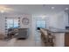 Bright living room with tile flooring, neutral furniture, and bar seating at the kitchen counter at 3818 Carrick Bend Dr, Kissimmee, FL 34746