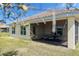 A patio with outdoor dining table and chairs and a screened in porch at 3818 Carrick Bend Dr, Kissimmee, FL 34746
