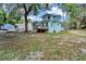 Exterior view of the home's spacious backyard, shed, and deck for outdoor living at 415 S 9Th St, Leesburg, FL 34748