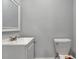 Powder room with white toilet and vanity at 415 S 9Th St, Leesburg, FL 34748