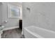 Bathroom featuring white tile bathtub surround and dark wood vanity at 415 S 9Th St, Leesburg, FL 34748