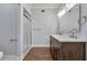 Bright bathroom featuring double vanity with stone countertops and walk-in shower at 415 S 9Th St, Leesburg, FL 34748