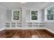 Bedroom with built-in shelving, hardwood floors, and a view of mature trees at 415 S 9Th St, Leesburg, FL 34748