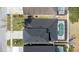 Aerial view of the property, highlighting the roof, the screened-in pool, and surrounding neighborhood at 4411 Great Harbor Ln, Kissimmee, FL 34746