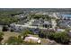 An overhead shot showcases a neighborhood with swimming pools and a mix of single-Gathering homes near a forest at 4411 Great Harbor Ln, Kissimmee, FL 34746