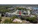 Aerial view of home featuring mature trees, landscaping, pool, and neighborhood water views at 4411 Great Harbor Ln, Kissimmee, FL 34746