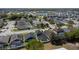 Beautiful aerial view of a residential neighborhood with houses featuring screened pools and a pond at 4411 Great Harbor Ln, Kissimmee, FL 34746