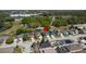 Aerial view of neighborhood home featuring mature trees, landscaping, and water views at 4411 Great Harbor Ln, Kissimmee, FL 34746