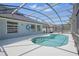 Inviting backyard pool with a screened enclosure and spacious patio area for entertaining and relaxation at 4411 Great Harbor Ln, Kissimmee, FL 34746